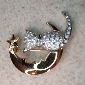 Pave rhinestone cat sitting on a crescent moon brooch